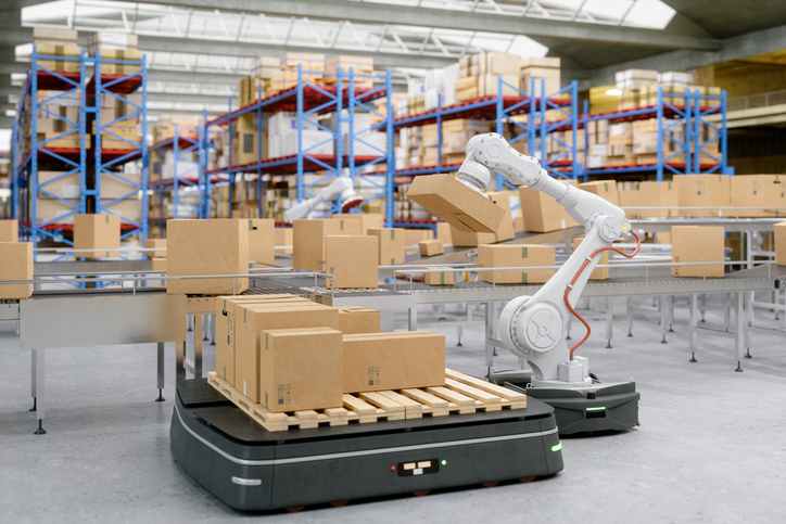 Robotic arm and carrier ready to move boxes in a Smart factory 