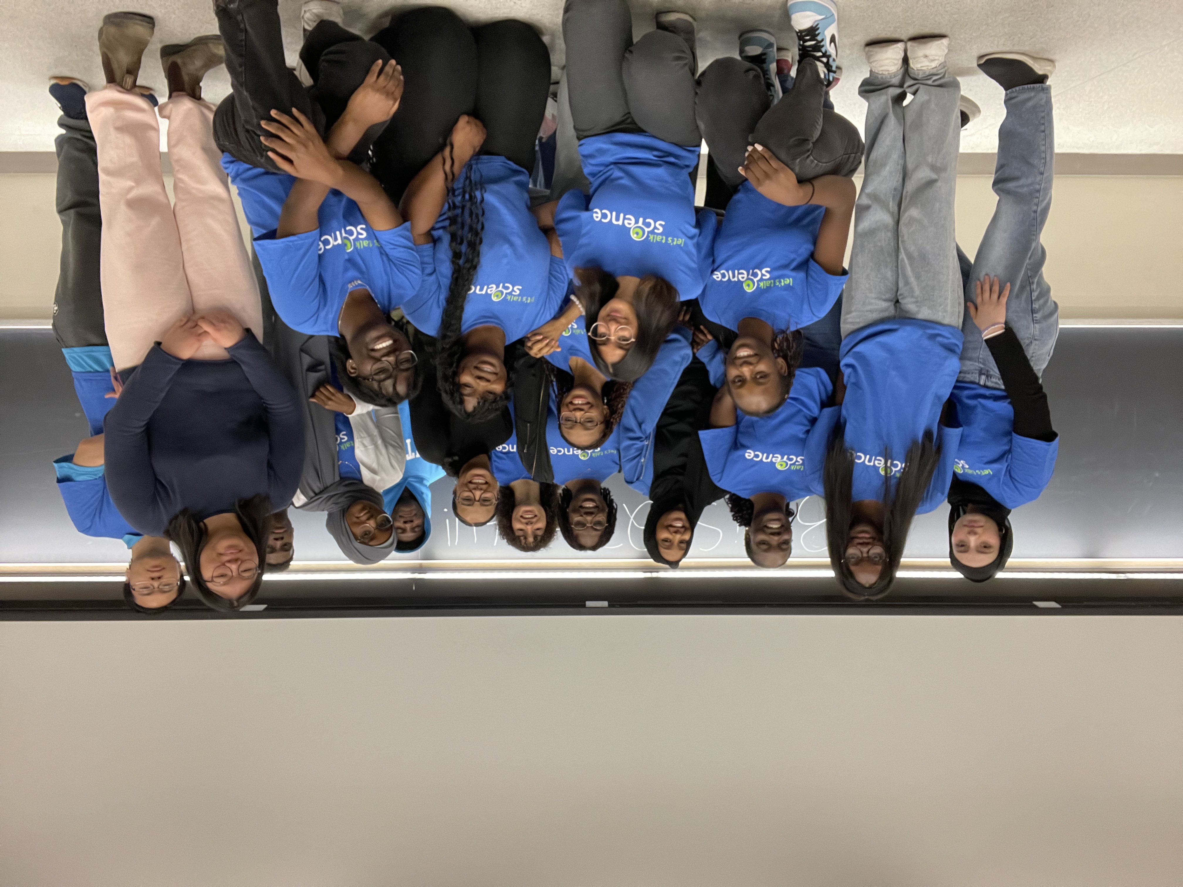 Black Youth in STEM volunteers in blue Let's Talk Science Shirts