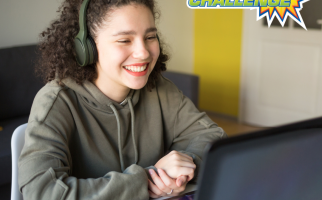 A girl watching her computer smiling