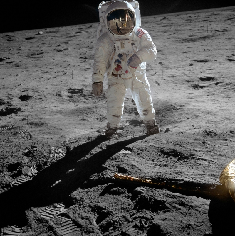 Buzz Aldrin on the Moon, with Neil Armstrong seen in the helmet's reflection. (1969)