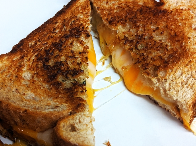 Gooey melted cheese inside a grilled sandwich