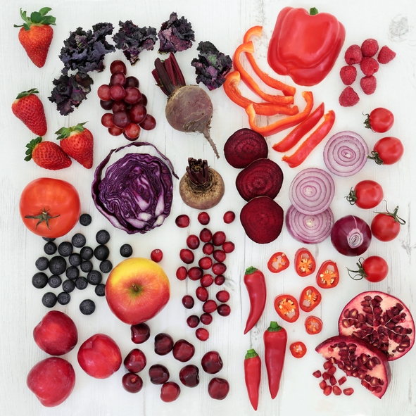 Collection of red-coloured foods, including peppers, strawberries, and pomegranate
