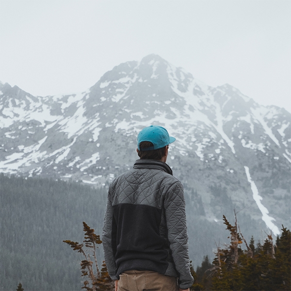 Homme regardant vers les montagnes