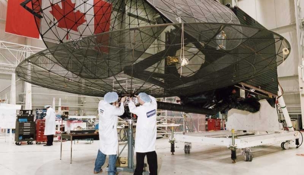 Engineers inspecting a satellite dish at the David Florida Lab
