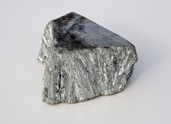 Shown is a colour photograph of a rough piece of grey, shiny material.