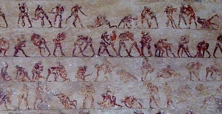 Shown is a colour photograph of painted human figures on a stone wall.