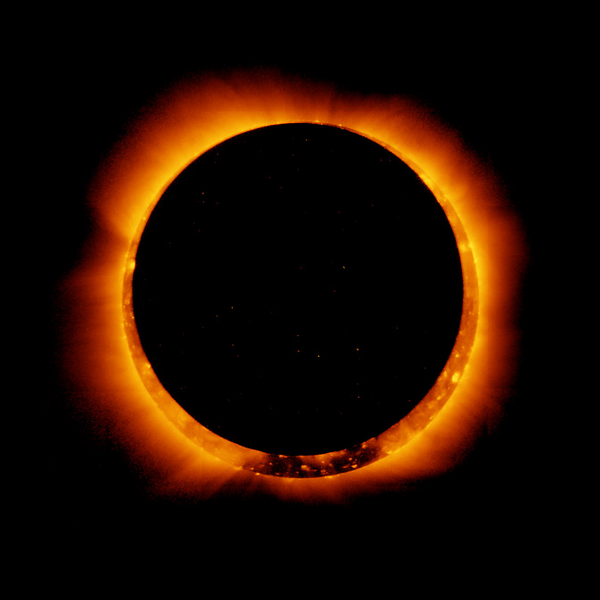 Shown is a colour photograph of a black disc with the glowing edge of the sun peeking out around it.