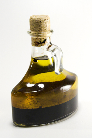 Shown is a colour photograph of a glass bottle filled with two different liquids.